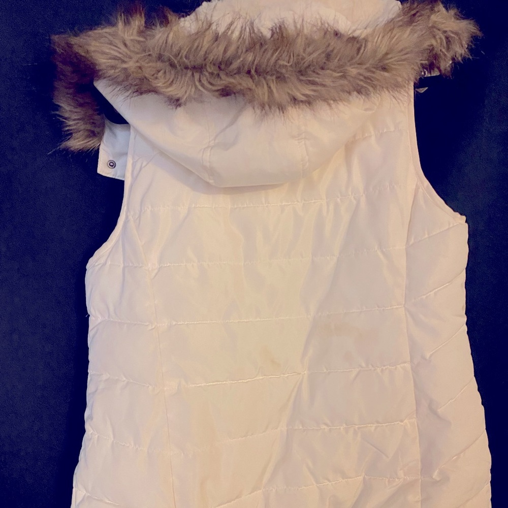 This cream cozy Green Tea Vest with a brown lined fur hood